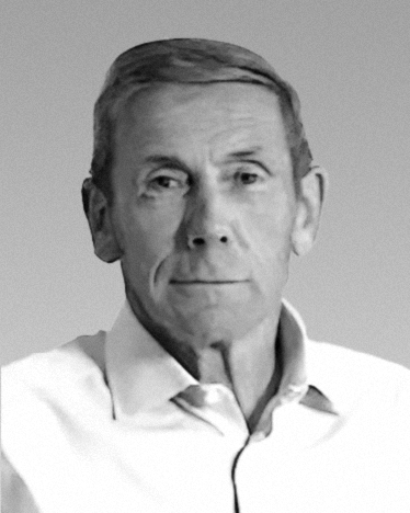 Black-and-white corporate headshot of a man wearing a light shirt. {{brizy_dc_image_alt imageSrc=