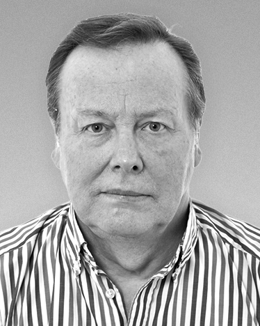 Black-and-white corporate portrait of a man wearing a striped shirt. {{brizy_dc_image_alt imageSrc=